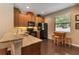 Charming kitchen with granite countertops, wooden cabinets, and a breakfast table near the window at 3637 Foxchase Dr, Clermont, FL 34711