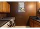 Practical laundry room with ample cabinet space, modern appliances, and a utility sink at 3637 Foxchase Dr, Clermont, FL 34711
