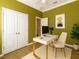 Bright office space featuring a modern white desk, neutral carpet, and ample closet storage at 3637 Foxchase Dr, Clermont, FL 34711