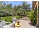 Relaxing patio area with lounge chairs and landscaping, creating a tranquil outdoor retreat for leisure and enjoyment at 3637 Foxchase Dr, Clermont, FL 34711