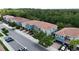 A row of modern townhomes features attached garages and a well-maintained streetscape at 366 Reed Grass Dr, Oviedo, FL 32765