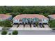Aerial view of the beautiful townhomes with red tile roofs, garages, and manicured landscaping at 366 Reed Grass Dr, Oviedo, FL 32765
