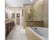 Bathroom with a soaking tub, glass shower enclosure, and double vanity at 366 Reed Grass Dr, Oviedo, FL 32765