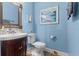 Cozy bathroom with light blue walls, decorative mirror and single sink vanity at 366 Reed Grass Dr, Oviedo, FL 32765