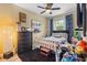 Bedroom with a dark accent wall, ceiling fan, and secondary decor at 366 Reed Grass Dr, Oviedo, FL 32765