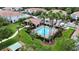 Aerial view of a neighborhood pool and cabana with palm trees in a well-maintained community at 366 Reed Grass Dr, Oviedo, FL 32765