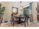 Charming dining area with a round table, stylish chairs, and sliding glass doors to the outdoors at 366 Reed Grass Dr, Oviedo, FL 32765