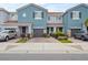 Charming blue two-story townhomes, each with a private garage and well-manicured landscaping at 366 Reed Grass Dr, Oviedo, FL 32765