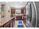 Well-lit kitchen featuring stainless steel appliances and an island with granite countertops at 366 Reed Grass Dr, Oviedo, FL 32765