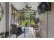 Bright sunroom with large windows, ceiling fan, comfortable seating, and view of the backyard at 366 Reed Grass Dr, Oviedo, FL 32765