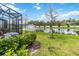 Scenic backyard view with waterfront, fountain, and screened in patio at 378 Cape Honeysuckle Pl, Sanford, FL 32771