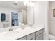 Bright bathroom featuring a double vanity and an expansive mirror at 378 Cape Honeysuckle Pl, Sanford, FL 32771
