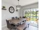 Dining area with table and seating plus sliding door to outdoor seating and a scenic view of the water at 378 Cape Honeysuckle Pl, Sanford, FL 32771