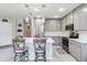 Bright kitchen with an island, stainless steel appliances, and modern light fixtures at 378 Cape Honeysuckle Pl, Sanford, FL 32771