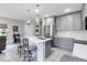 Modern kitchen features an island with stainless steel appliances and quartz countertops at 378 Cape Honeysuckle Pl, Sanford, FL 32771
