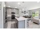 Modern kitchen with stainless steel appliances and an island with quartz countertops at 378 Cape Honeysuckle Pl, Sanford, FL 32771