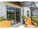 Covered patio with comfortable chairs offers serene water views at 378 Cape Honeysuckle Pl, Sanford, FL 32771