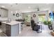 Bright, open-concept living space with modern furnishings, kitchen island, and sliding glass doors to the outdoors at 378 Cape Honeysuckle Pl, Sanford, FL 32771