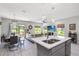 Open-concept kitchen and living area with stainless steel appliances and lots of natural light at 378 Cape Honeysuckle Pl, Sanford, FL 32771