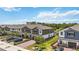 Townhomes with attached garages, brick driveways, and green spaces at 378 Cape Honeysuckle Pl, Sanford, FL 32771