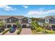 Charming townhomes boasting brick driveways, manicured landscaping, and attached garages at 378 Cape Honeysuckle Pl, Sanford, FL 32771