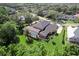 Aerial view of a beautiful home with a screened pool and lush landscaping, creating a private backyard oasis at 4048 Gilder Rose Pl, Winter Park, FL 32792