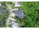 Aerial view showcasing the home's layout, pool, circular driveway, and lush surrounding greenery at 4048 Gilder Rose Pl, Winter Park, FL 32792