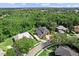 Spacious home features a lush green landscape, expansive driveway, and a private setting backing to a forest at 4048 Gilder Rose Pl, Winter Park, FL 32792