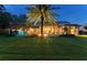 Enclosed backyard with sparkling pool, covered outdoor living and towering palm trees at 4048 Gilder Rose Pl, Winter Park, FL 32792