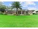 This large backyard with manicured lawn highlights the screened lanai and inviting pool at 4048 Gilder Rose Pl, Winter Park, FL 32792