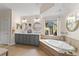 Bright primary bathroom features double vanity, large tub, and access to outdoor courtyard at 4048 Gilder Rose Pl, Winter Park, FL 32792