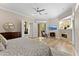 Primary bedroom with a fireplace, TV and dresser at 4048 Gilder Rose Pl, Winter Park, FL 32792