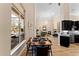 Open concept living with dining area leading to kitchen and featuring large windows at 4048 Gilder Rose Pl, Winter Park, FL 32792