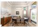 Elegant dining room with a modern light fixture, large window, and stylish decor at 4048 Gilder Rose Pl, Winter Park, FL 32792