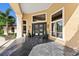 Elegant entrance with large windows, double doors, and stylish tile flooring and manicured landscaping at 4048 Gilder Rose Pl, Winter Park, FL 32792