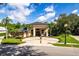 Elegant home featuring a circular driveway, mature landscaping and grand entrance with stately columns at 4048 Gilder Rose Pl, Winter Park, FL 32792