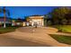 Beautiful home featuring a circular driveway, manicured landscaping, and an elegant front entrance at 4048 Gilder Rose Pl, Winter Park, FL 32792