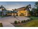 Stunning home featuring a circular driveway and grand entrance with columns and mature landscaping at 4048 Gilder Rose Pl, Winter Park, FL 32792