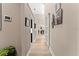 Bright hallway with wood floors, neutral walls, accent wall decor, and leads to dining room and other rooms at 4048 Gilder Rose Pl, Winter Park, FL 32792