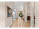 Inviting hallway with hardwood floors, decorative columns, and an open view to the living area at 4048 Gilder Rose Pl, Winter Park, FL 32792