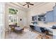 Bright home office with custom built-ins, a large window, and a comfortable seating area at 4048 Gilder Rose Pl, Winter Park, FL 32792