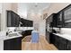 Modern kitchen with black cabinetry, a center island, and stainless steel appliances at 4048 Gilder Rose Pl, Winter Park, FL 32792