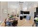 Open concept kitchen featuring modern appliances, black cabinets, and a center island with seating at 4048 Gilder Rose Pl, Winter Park, FL 32792