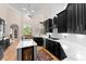 Bright kitchen with black cabinets, quartz countertops, wine cooler, and a breakfast nook at 4048 Gilder Rose Pl, Winter Park, FL 32792
