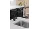 Close up of kitchen sink featuring modern fixtures and sleek quartz countertops at 4048 Gilder Rose Pl, Winter Park, FL 32792