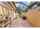 Relaxing lanai space with brick floors, plants and a partial sun roof at 4048 Gilder Rose Pl, Winter Park, FL 32792