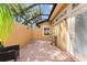 Private lanai with brick floors and a tranquil sitting area at 4048 Gilder Rose Pl, Winter Park, FL 32792