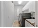 Laundry room with new washer and dryer, storage cabinets, and utility sink at 4048 Gilder Rose Pl, Winter Park, FL 32792