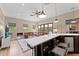 Spacious living area featuring a fireplace, a large leather sofa, and an adjacent wet bar with barstool seating at 4048 Gilder Rose Pl, Winter Park, FL 32792