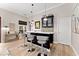 Open-concept living area featuring a modern bar with seating and stylish decor, complemented by views of the outdoors at 4048 Gilder Rose Pl, Winter Park, FL 32792